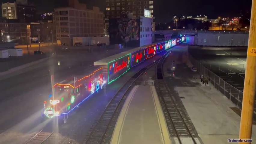 CP Christmas train at night on the move at KCUS bridge.